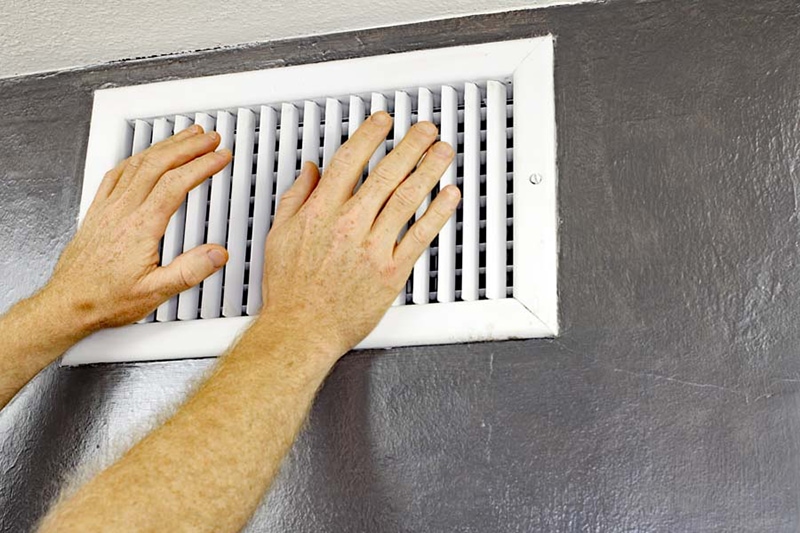 hands over white air vent